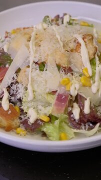 Closeup chef ipresenting delicious caesar salad on camera. slow motion. High quality FullHD footage