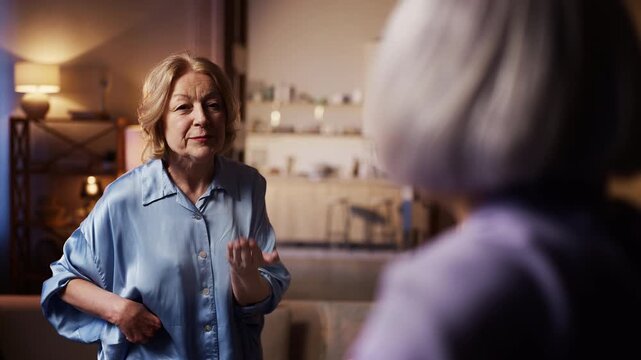 Annoyed senior woman arguing with best female friend, stress, disagreement