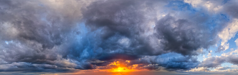 Dramatic Storm Clouds Over Vibrant Sunset Horizon With Moody Sky and Golden Light