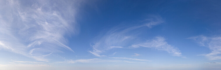 Serene Blue Sky With Wispy Cirrus Clouds Over Distant Horizon Cloudscape