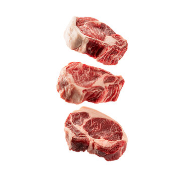 Raw meat steaks with green leaves on white background isolated on a transparent background