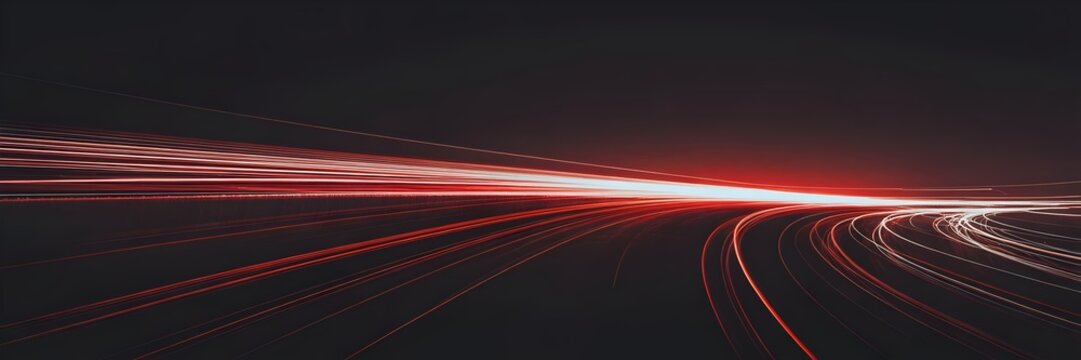 Red light trails from car headlights on a dark road at night, creating a sense of speed and urban movement.