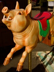 vintage pig themed carousel ride 