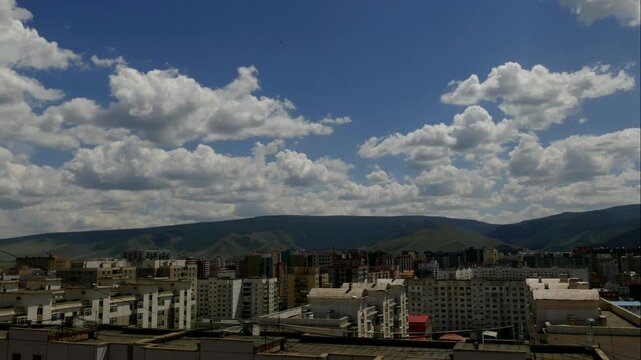 Painterly flying clouds over the city and mountains, time lapse. Ulaanbaatar, Mongolia.