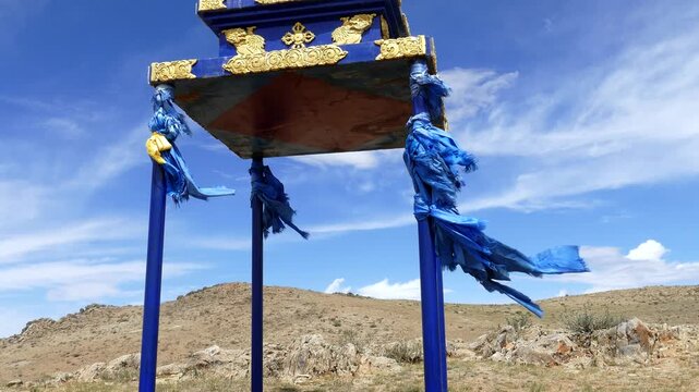  Buddhist ritual building of stupa on the background of the picturesque cloudy sky in the Mongolian steppe. On a Sunny summer day.
