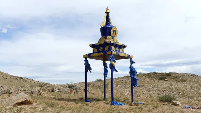  Buddhist ritual building of stupa on the background of the picturesque cloudy sky in the Mongolian steppe. On a Sunny summer day.