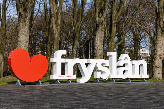Large white "frysl&acirc;n" letters with a red heart in a park setting. Iconic Frisian landmark promoting tourism in Friesland, Netherlands. Heerenveen, Netherlands, 26 february 2026
