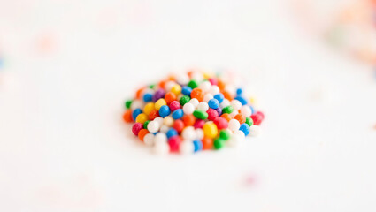 Bright colored sprinkles placed on a flat surface for decoration in a bright setting