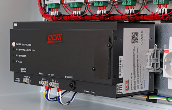 An uninterruptible power supply from Powercom is installed on a metal DKC circuit board. 