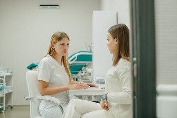Fototapeta premium Doctor consulting patient during healthcare discussion in clinic