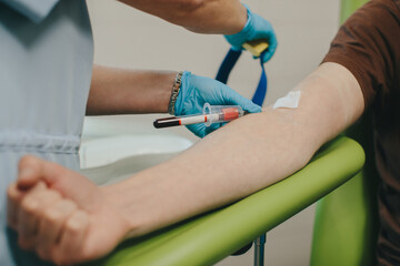 Healthcare professional collecting blood sample from patient arm