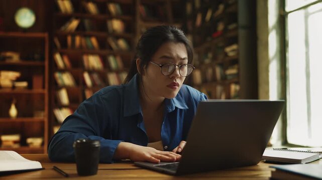 Korean female student facing laptop software issue, upset about deleted file