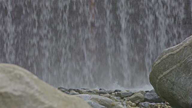 Water falls from man made cascade. Falling water close up. Cascatella waterfall near Novate Mezzola, Italy.