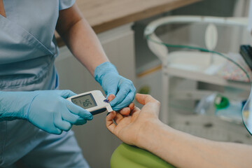 Healthcare professional performing blood glucose test in clinic