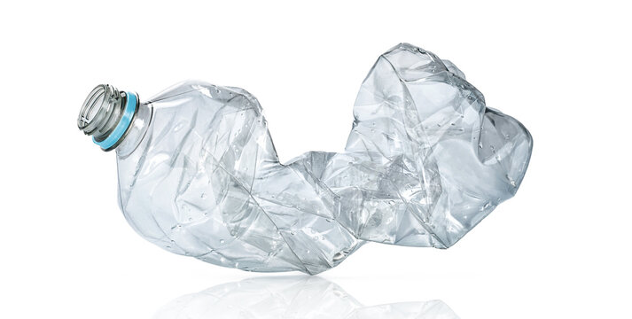 Crushed clear plastic bottle waste on white background isolated, recycling and environmental pollution concept