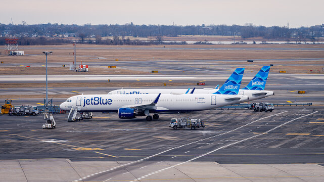 JetBlue Airbus A321 Aircraft Parked at JFK Airport with Ground Service Vehicles &ndash; New York, USA