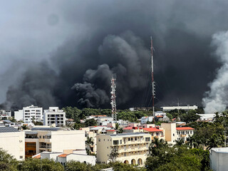 Naklejka premium Dark clouds as a result of burning vehicles in Puerto Vallarta. February 2026. Damage by drug cartel.