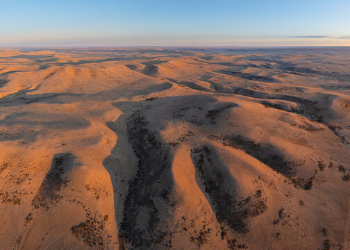 Aerial view over the rolling hills of the desert and pampas of north Patagonia in the vicinity of Baja Caracoles at sunset, Argentina