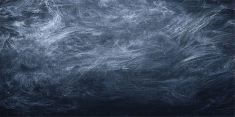 An abstract storm of dark blue smoke swirls against a black and white chalk board texture creating a moody motion pattern of clouds and fog © PAGLAA