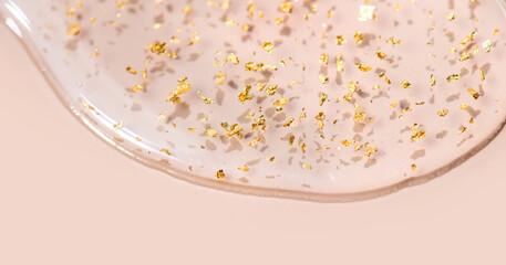 Serum fluid 24k gold gel facial cream smear on beige pastel background. Beauty cosmetic product...