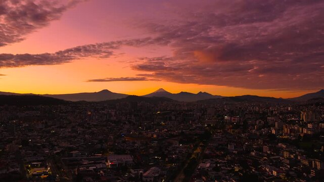 Quito, Ecuador at sunrise with the majestic Cotopaxi volcano visible in the background.