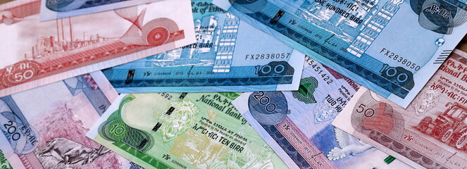 Ethiopian birr money bills pile on table. Ethiopia banknotes of ETB currency close up.