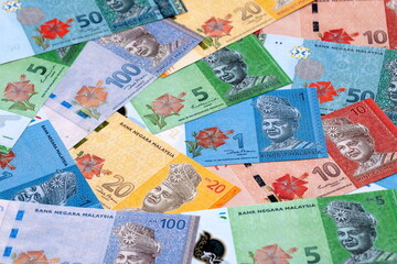 Malaysian ringgit money bills pile on table. Malaysia banknotes of MYR currency close up.