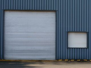 Metal gate and window to a warehouse on an industrial site