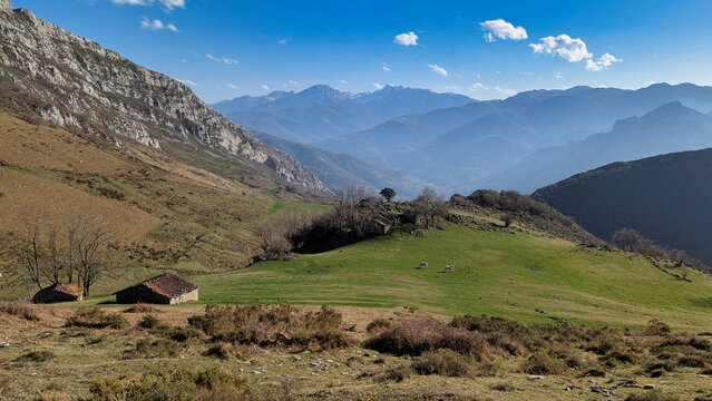Stone shepherd's huts stands on a grassy slope in the Bra&ntilde;a de La Mortera, near the village of Tene in Quir&oacute;s, Asturias, Spain
