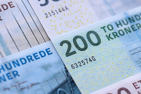 Danish krone paper banknotes pile on table. Denmark DKK currency money bills in big amount. Concept of economics, taxation and banking in Denmark