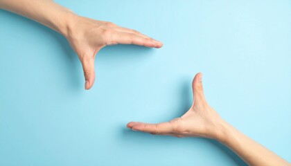 Two Hands Reaching Towards Each Other Against a Soft Blue Background Symbolizing Connection and Unity