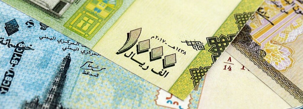 Yemeni rial paper banknotes pile on table. Yemen YER currency money bills in big amount. Concept of economics, taxation and banking in Yemen