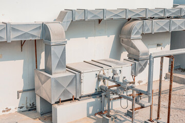 Industrial HVAC system providing ventilation and climate control on a building rooftop. Modern technology maintaining comfortable indoor environments