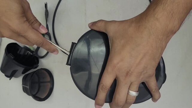 Broken electric coffee maker being disassembled