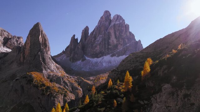 Zw&ouml;lferkofel Croda dei Toni peak in Dolomites, Italy. Golden larch trees on mountain hill in autumn.