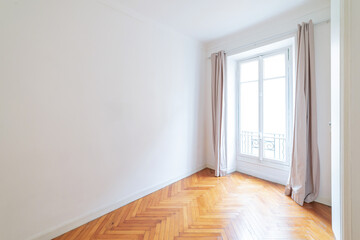 Fototapeta premium Empty white room with herringbone wooden floor and tall window.