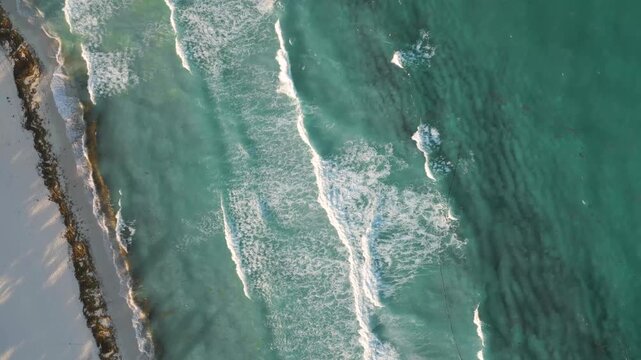 Aerial Top-Down View of Ocean Waves Crashing on Tropical Beach in Playa del Carmen Mexico