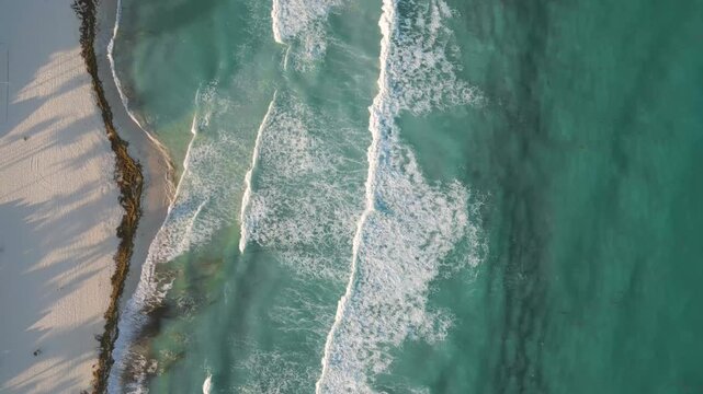Aerial Top-Down View of Ocean Waves Crashing on Tropical Beach in Playa del Carmen Mexico