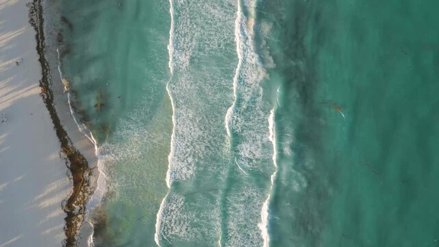 Aerial Top-Down View of Ocean Waves Crashing on Tropical Beach in Playa del Carmen Mexico