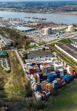 Canada, BC, Delta.  Aerial view of shipping container storage facility and LNG storage near the banks of the Fraser River