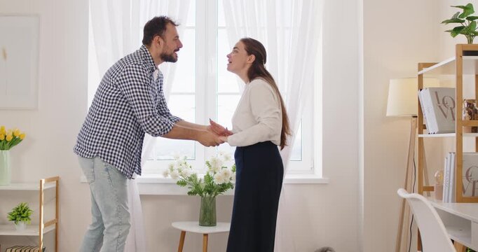 Couple during stress arguments and fight at home by window. Unhappy man and woman quarrel in anger, domestic dispute and breakup talk of angry partners about crisis, husband saying Sorry to wife