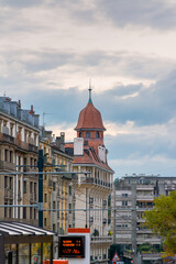 Obraz premium Tram lines leading to historic tower in city