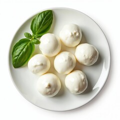 Small mozzarella balls with fresh basil leaves sit on a white plate. This appetizer or ingredient is perfect for Italian dishes and light meals. Fresh cheese and herb presentation.