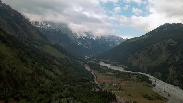 Aerial view of Valbone National Park valley, Albania. Vast landscape of a big river floating between high mountains