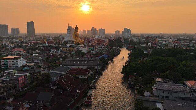 Aerial view Wat Paknam Bhasicharoen with wooden boat on river located in Phasi Charoen district, Bangkok, at the Chao Phraya River. It is part of the Maha Nikaya fraternity and is the origin of the Dh