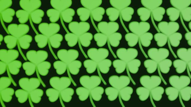 A 3d animation of repetitive, seamless pattern of green three-leaf clovers (shamrocks), commonly associated with St. Patrick's Day, Irish culture, and themes of luck.