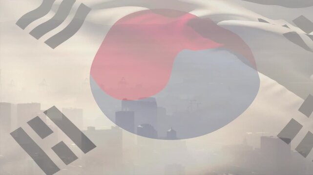 Wind starting, large flag with Taegeuk rippling and folding over hazy skyline, shifting visibility