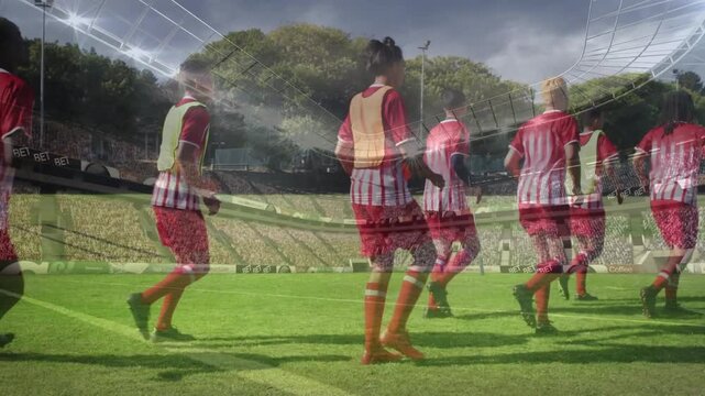 Soccer team doing leg swings jogging on pitch, whistle starting transparent overlay, prepping match