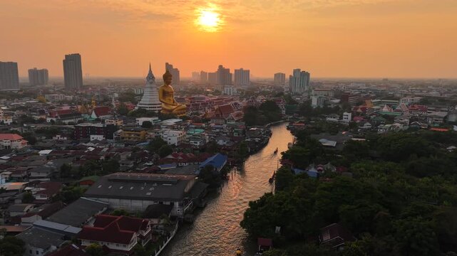Aerial view Wat Paknam Bhasicharoen with wooden boat on river located in Phasi Charoen district, Bangkok, at the Chao Phraya River. It is part of the Maha Nikaya fraternity and is the origin of the Dh