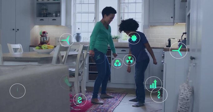 Mom guiding son stepping on rug in kitchen, sparking round edu icons around feet, training steps